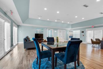 Clubhouse with multiple seating arrangements and a lounge area at Crystal Lake in Pensacola, Florida.